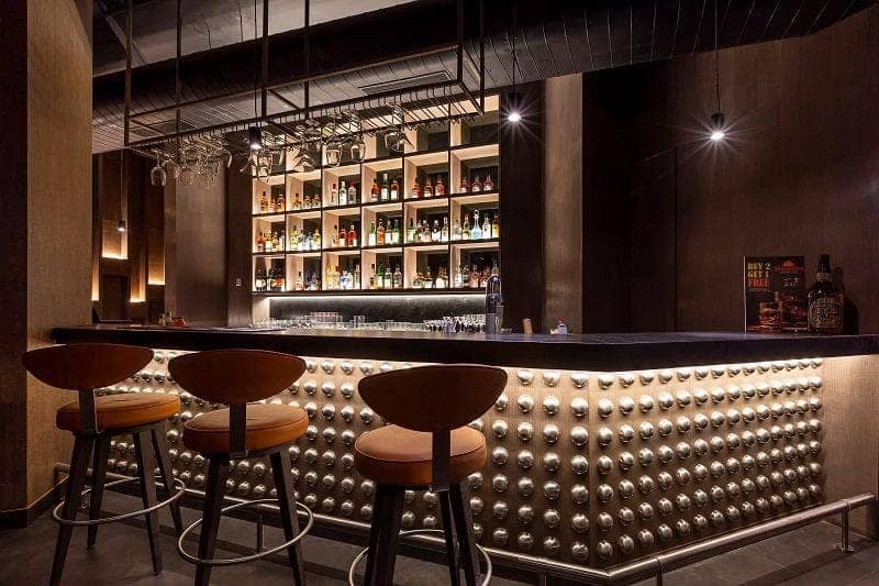 Hospitality bar and lounge interior with backlit metal detailing