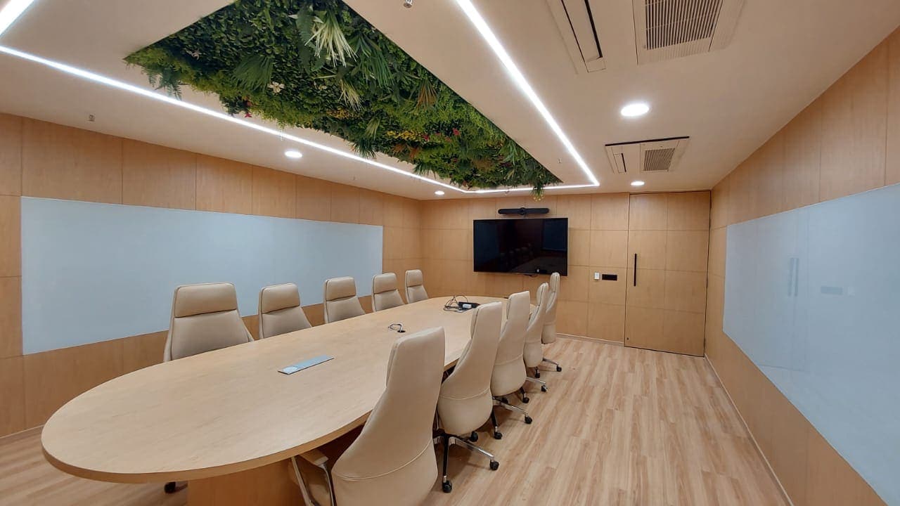 Open-plan office with workstation clusters and glazed meeting rooms