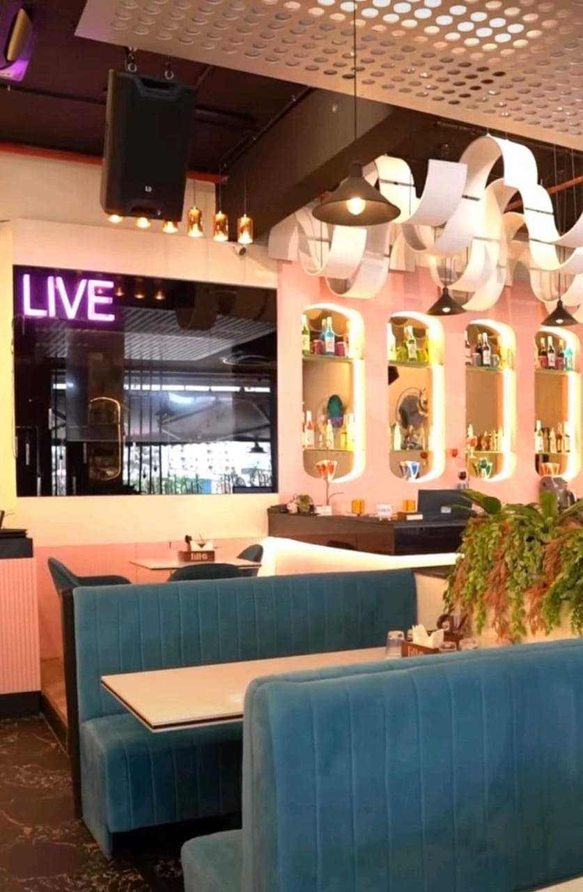 Restaurant dining room with banquette seating and pendant lighting